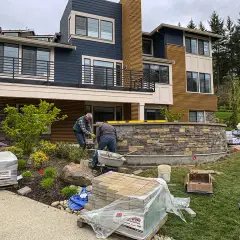 Rebuilt block retaining wall with new drainage behind it on a Bellevue slope