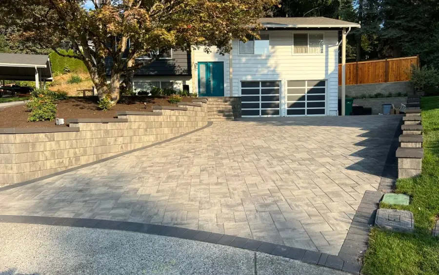 Wide paver driveway and turning apron in front of a garage on a sloped Issaquah lot