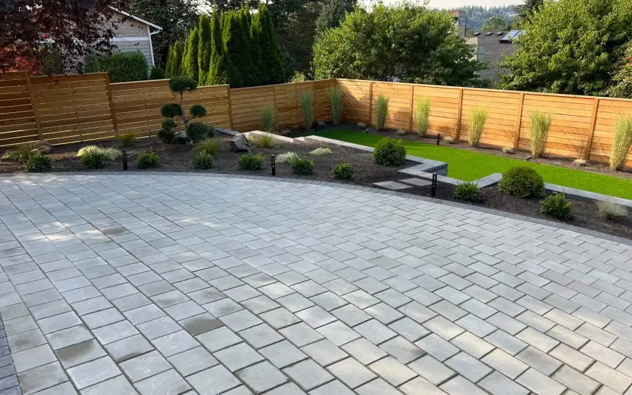 Large paver patio with artificial turf lawn, new planting beds and horizontal cedar fencing in Kirkland
