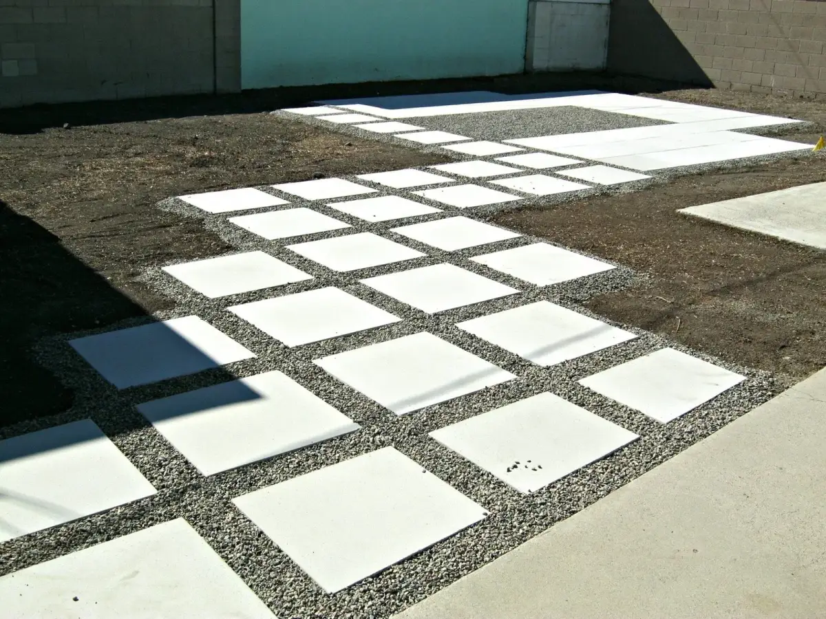 Large-format concrete pavers laid tight into a modern garden with a clean restrained edge
