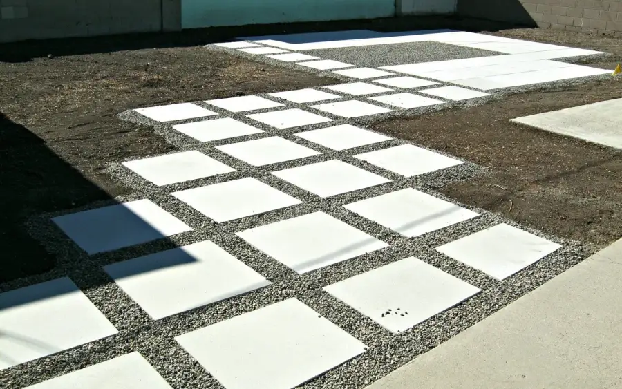 Large-format concrete pavers laid tight into a modern garden with a clean restrained edge